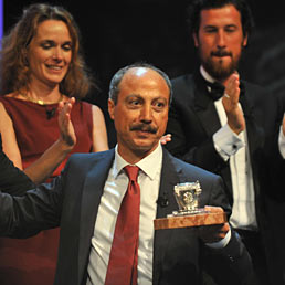 Nella foto al centro il vincitore della Cinquantesima edizione del Premio Letterario Campiello, Carmine Abate ("La collina del vento", Mondadori), posa col premio appena ricevuto sul palco del gran teatro La Fenice di Venezia. Alle sue spalle gli altri quattro scrittori finalisti (Ansa)