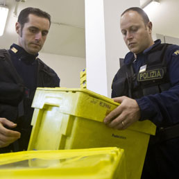 Artificieri della polizia mentre bonificano scatole in plastica contenenti lettere sospette (ANSA/MASSIMO PERCOSSI)